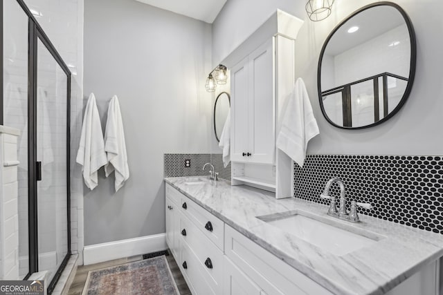 1211 Mortimer Pl SE, Atlanta, GA 30317 - bathroom with a shower stall, double vanity, tasteful backsplash, and baseboards