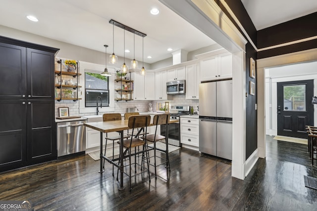 1211 Mortimer Pl SE, Atlanta, GA 30317 - kitchen with stainless steel appliances, open shelves, tasteful backsplash, dark wood-type flooring, and recessed lighting