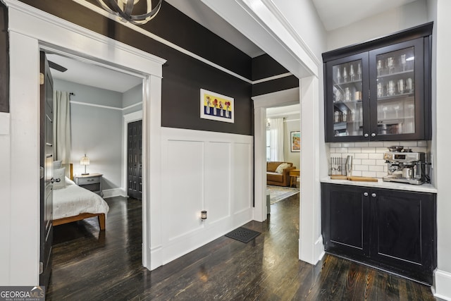 1211 Mortimer Pl SE, Atlanta, GA 30317 - bar featuring dark wood-style floors, tasteful backsplash, and a wainscoted wall