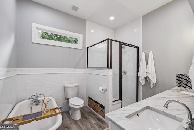 1211 Mortimer Pl SE, Atlanta, GA 30317 - full bath with a shower stall, wood finished floors, a freestanding tub, tile walls, and toilet