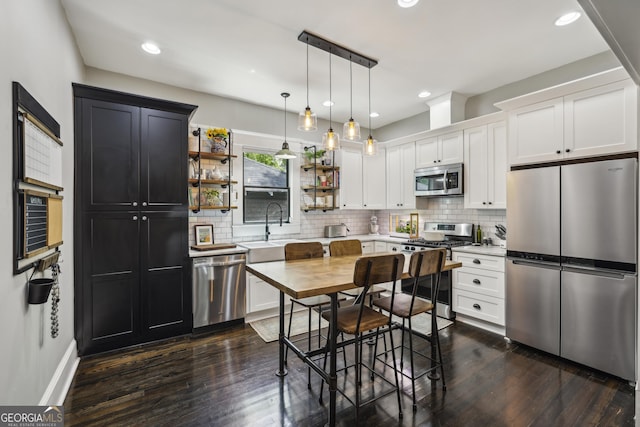 1211 Mortimer Pl SE, Atlanta, GA 30317 - kitchen with stainless steel appliances, open shelves, dark wood-type flooring, light countertops, and recessed lighting