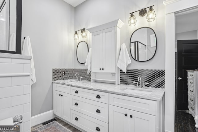 1211 Mortimer Pl SE, Atlanta, GA 30317 - bathroom with tasteful backsplash, wood finished floors, double vanity, and baseboards