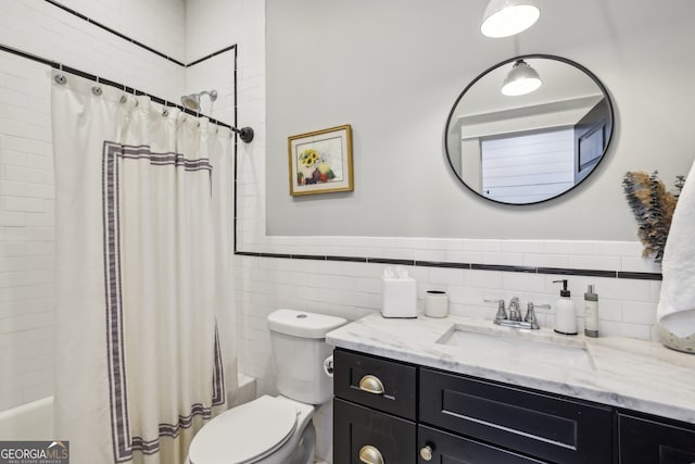 1211 Mortimer Pl SE, Atlanta, GA 30317 - full bathroom featuring tile walls, vanity, shower / bath combo, toilet, and a wainscoted wall