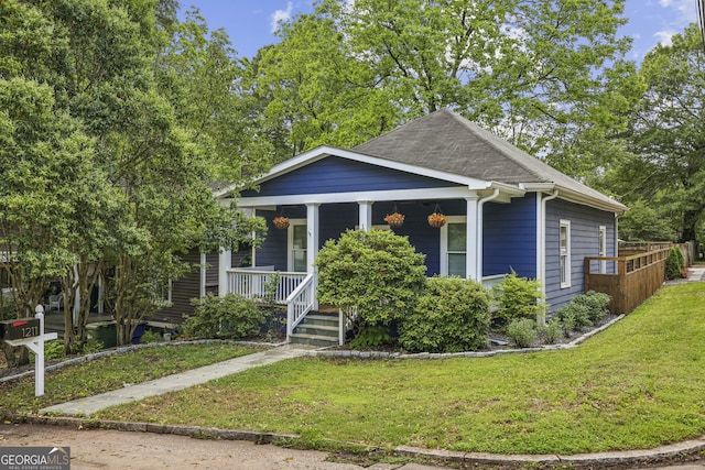 1211 Mortimer Pl SE, Atlanta, GA 30317 - view of front facade featuring covered porch, a front yard, and roof with shingles