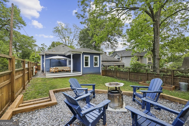 1211 Mortimer Pl SE, Atlanta, GA 30317 - rear view of property featuring an outdoor living space with a fire pit and a shingled roof