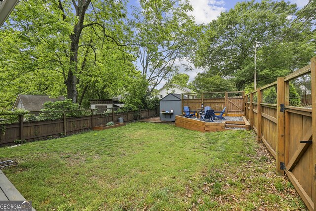 1211 Mortimer Pl SE, Atlanta, GA 30317 - view of yard featuring a storage unit, an outdoor structure, and a garden