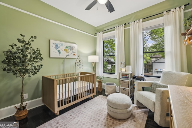 1211 Mortimer Pl SE, Atlanta, GA 30317 - bedroom featuring a nursery area, wood finished floors, baseboards, and ceiling fan