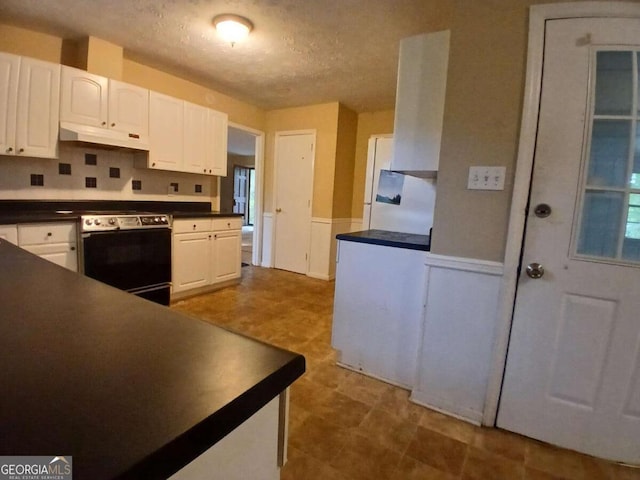 3026 Hidden Forest Dr, Snellville, GA 30078 - kitchen featuring electric stove, under cabinet range hood, dark countertops, white cabinetry, and tile patterned floors