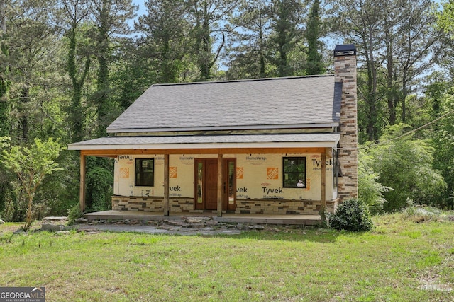 2003 Greeson Rd, Dacula, GA 30019 - view of front of property featuring covered porch, a shingled roof, a front lawn, and a chimney