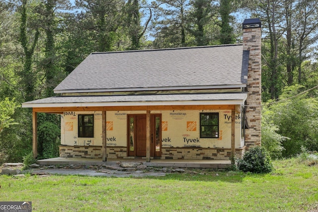 2003 Greeson Rd, Dacula, GA 30019 - view of front of home with covered porch, a shingled roof, a chimney, and a front yard