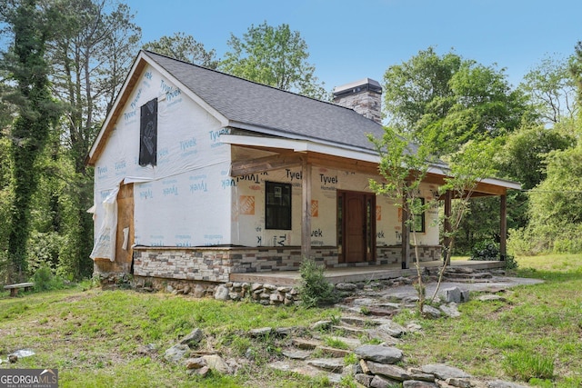 2003 Greeson Rd, Dacula, GA 30019 - unfinished property with a porch, a chimney, and a shingled roof