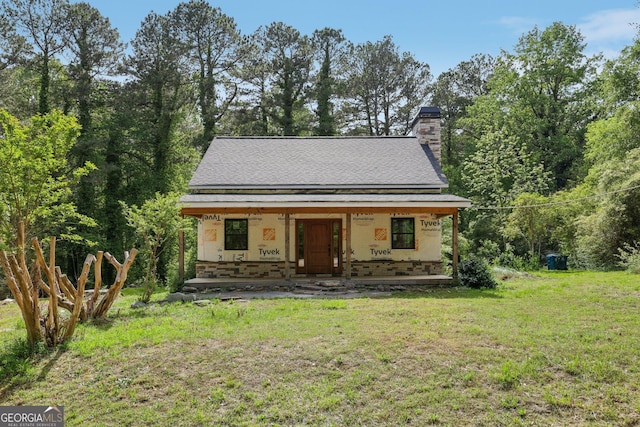 2003 Greeson Rd, Dacula, GA 30019 - view of front of house featuring covered porch, a front lawn, and a chimney