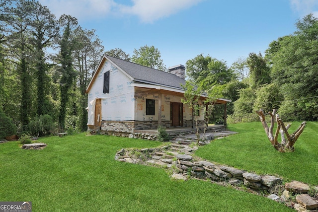 2003 Greeson Rd, Dacula, GA 30019 - view of front of home featuring a chimney, a front yard, and stone siding