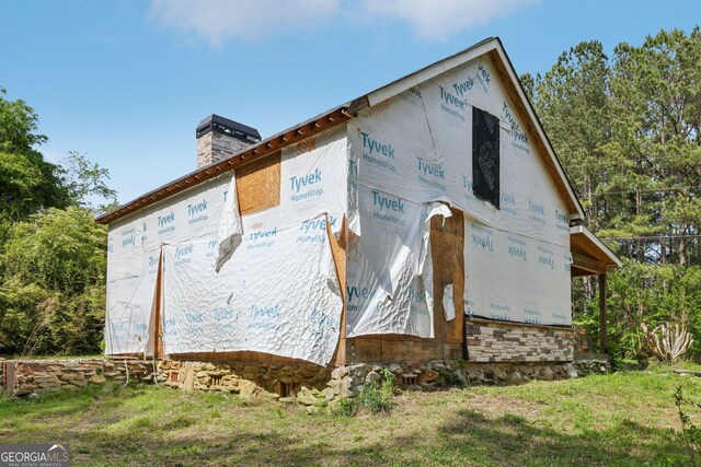 2003 Greeson Rd, Dacula, GA 30019 - view of home's exterior with a chimney