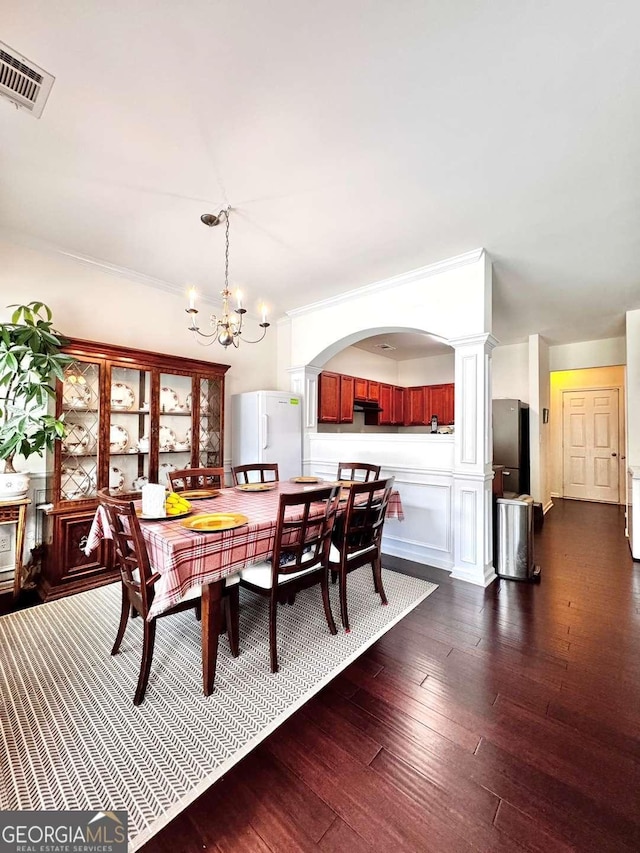 dining room with a chandelier and dark wood-style flooring