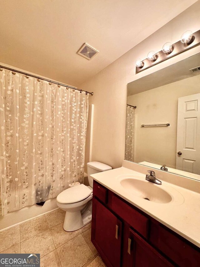 bathroom featuring vanity, toilet, and tile patterned floors
