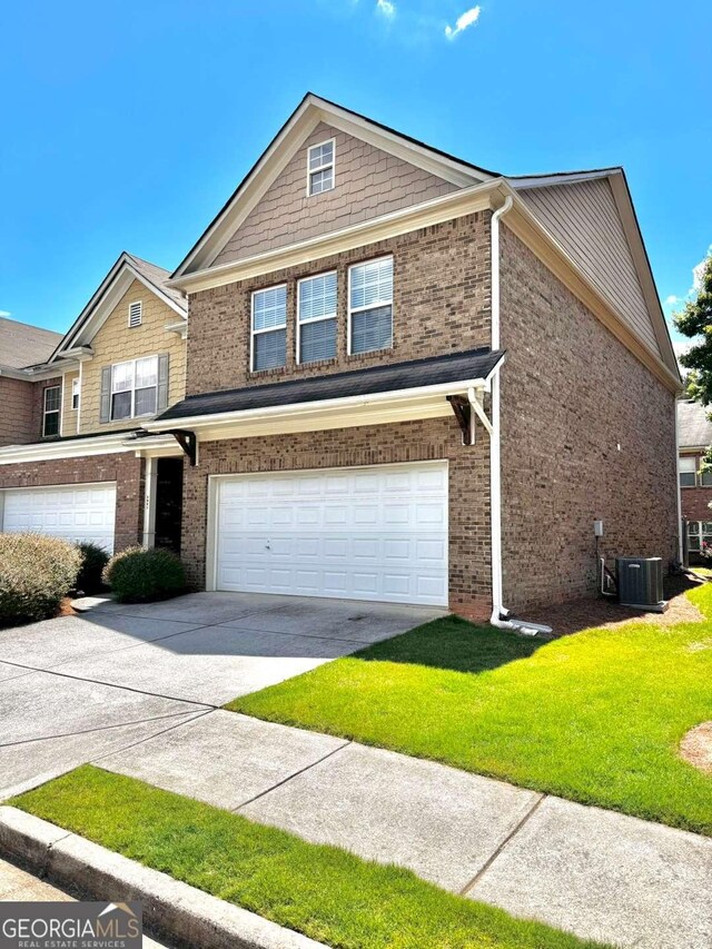 view of front facade with concrete driveway, an attached garage, brick siding, a front yard, and cooling unit