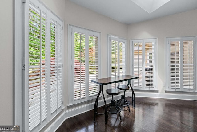 dining space featuring wood finished floors and baseboards