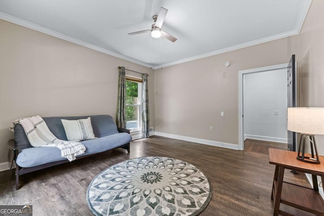 living area with a ceiling fan, wood finished floors, baseboards, and crown molding