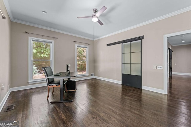 home office featuring a barn door, wood finished floors, crown molding, baseboards, and a ceiling fan