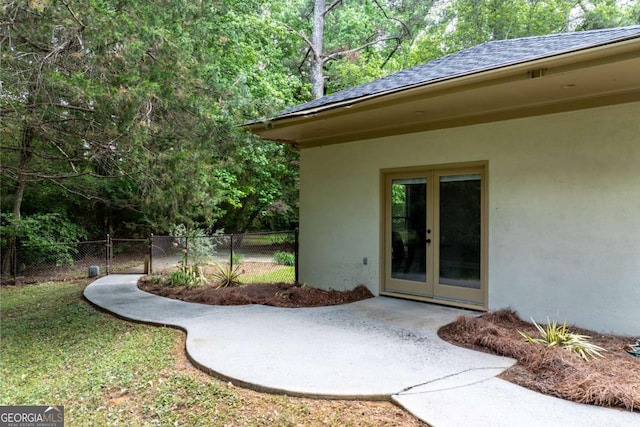 view of yard featuring french doors, fence, and a patio