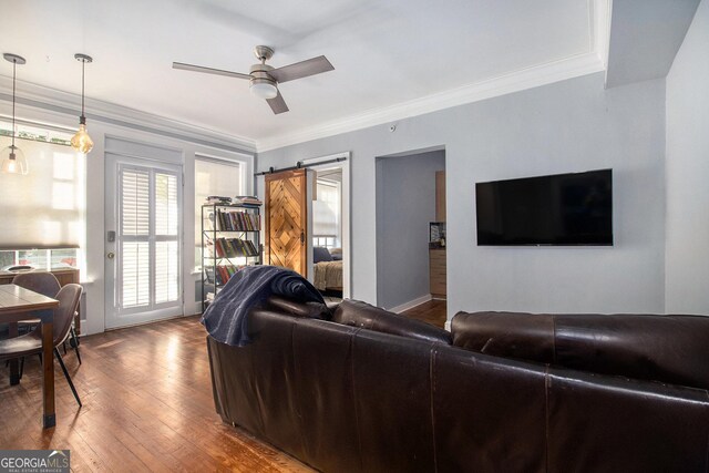 61 16th St NE Unit 4, Atlanta, GA 30309 - living room featuring wood finished floors, a ceiling fan, a barn door, and crown molding