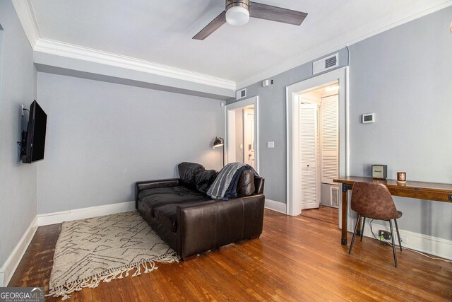61 16th St NE Unit 4, Atlanta, GA 30309 - living room with ornamental molding, wood finished floors, a ceiling fan, and baseboards