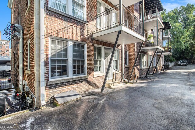 61 16th St NE Unit 4, Atlanta, GA 30309 - view of side of home with brick siding and entry steps