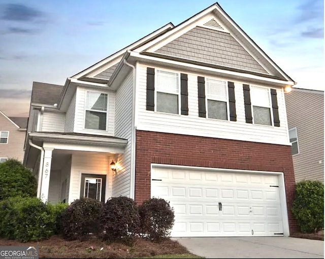 867 Crested Hawk Trl, Sugar Hill, GA 30518 - view of front of home featuring a garage, brick siding, and driveway