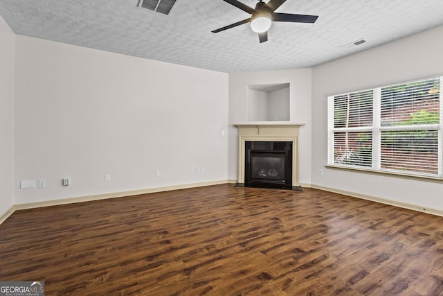 867 Crested Hawk Trl, Sugar Hill, GA 30518 - unfurnished living room featuring wood finished floors, a ceiling fan, a textured ceiling, and a fireplace with flush hearth