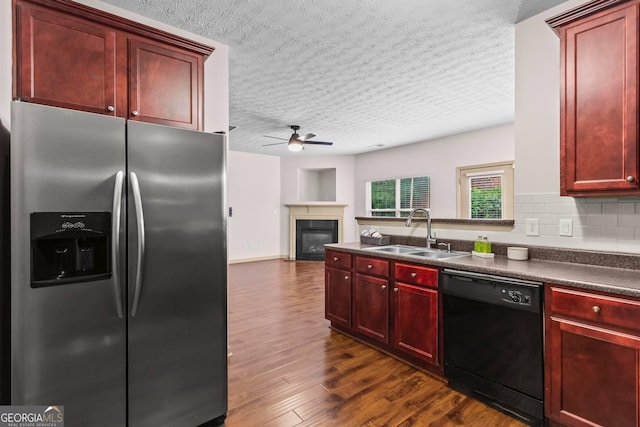 867 Crested Hawk Trl, Sugar Hill, GA 30518 - kitchen with stainless steel fridge with ice dispenser, dishwasher, reddish brown cabinets, dark countertops, and a textured ceiling