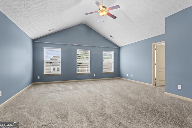 867 Crested Hawk Trl, Sugar Hill, GA 30518 - empty room featuring a ceiling fan, lofted ceiling, carpet flooring, and a textured ceiling