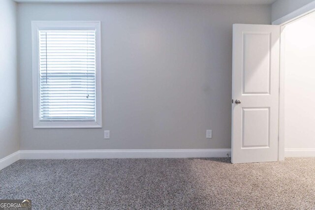 4183 May Apple Ln, Atlanta, GA 30349 - spare room featuring carpet flooring and baseboards