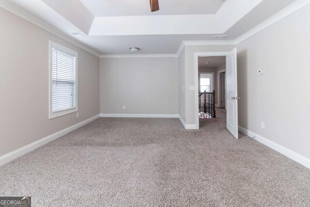 4183 May Apple Ln, Atlanta, GA 30349 - carpeted spare room featuring a tray ceiling, a ceiling fan, baseboards, and crown molding