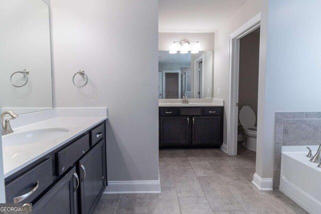 4183 May Apple Ln, Atlanta, GA 30349 - bathroom with baseboards, toilet, a garden tub, and tile patterned flooring