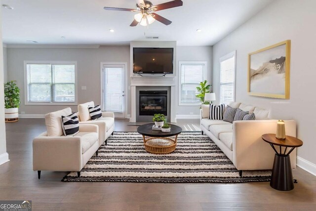 4183 May Apple Ln, Atlanta, GA 30349 - living area with baseboards, wood finished floors, a ceiling fan, a glass covered fireplace, and recessed lighting