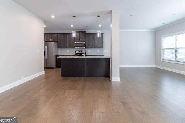 4183 May Apple Ln, Atlanta, GA 30349 - kitchen featuring appliances with stainless steel finishes, open floor plan, dark wood-style floors, decorative backsplash, and recessed lighting