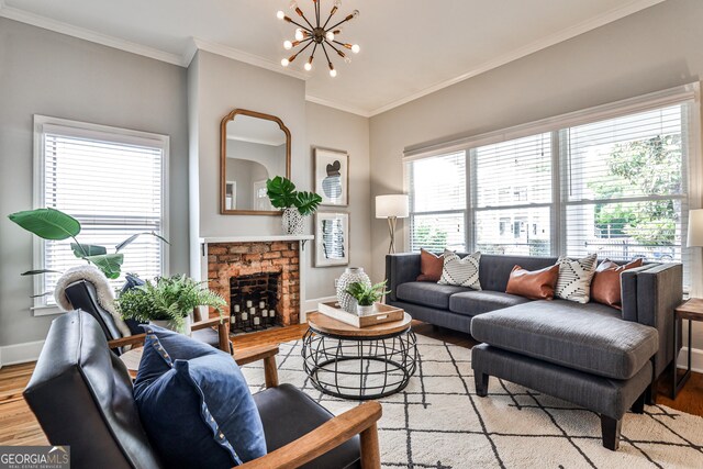 32 Howell St SE, Atlanta, GA 30312 - living room with light wood-type flooring, a chandelier, plenty of natural light, a brick fireplace, and ornamental molding