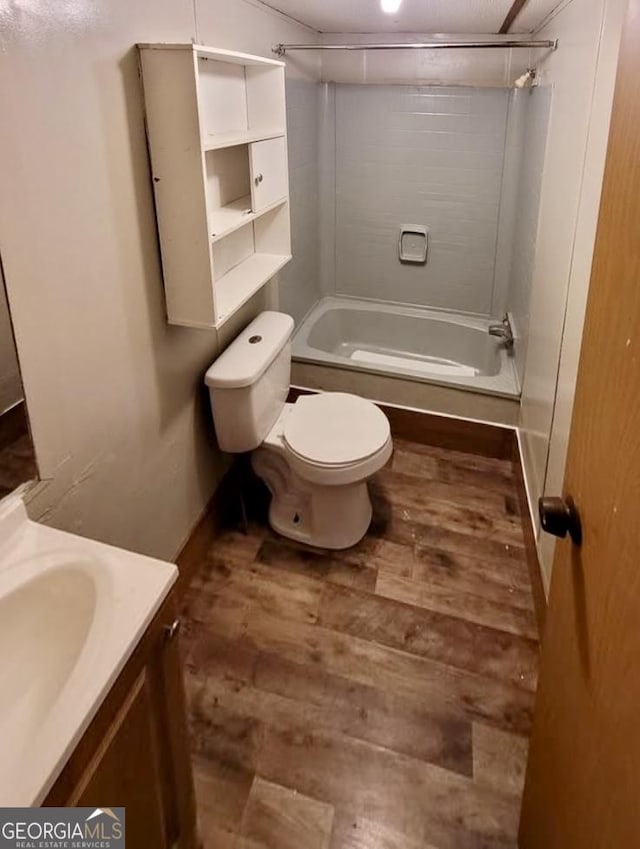 916 Friendly Mission Ln, Cornelia, GA 30531 - bathroom with toilet, vanity, wood finished floors, and  shower combination