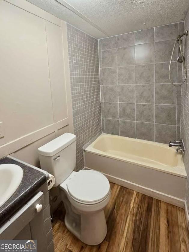 916 Friendly Mission Ln, Cornelia, GA 30531 - full bathroom with wood finished floors, bathtub / shower combination, a textured ceiling, and toilet