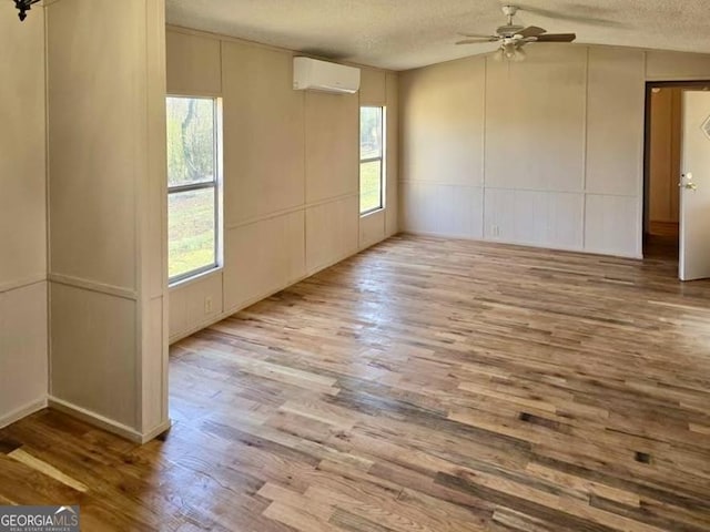 916 Friendly Mission Ln, Cornelia, GA 30531 - empty room featuring a wall mounted air conditioner, a textured ceiling, wood finished floors, ceiling fan, and a decorative wall