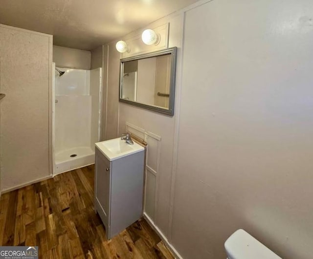 916 Friendly Mission Ln, Cornelia, GA 30531 - full bath with a stall shower, wood finished floors, toilet, and vanity