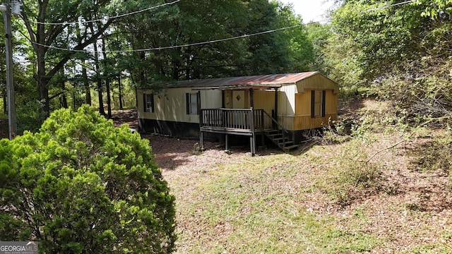916 Friendly Mission Ln, Cornelia, GA 30531 - rear view of house with metal roof and a wooded view