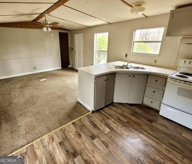 916 Friendly Mission Ln, Cornelia, GA 30531 - kitchen with white range with electric cooktop, a sink, range hood, a ceiling fan, and a peninsula