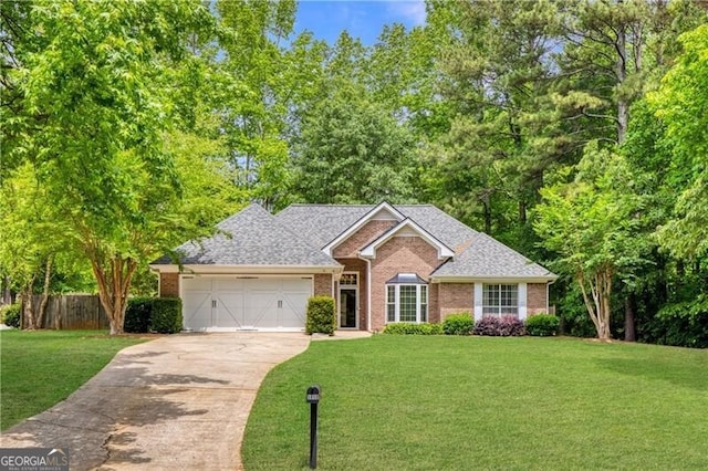 5850 Shannon Dr, Cumming, GA 30040 - view of front facade featuring a garage, driveway, brick siding, and roof with shingles