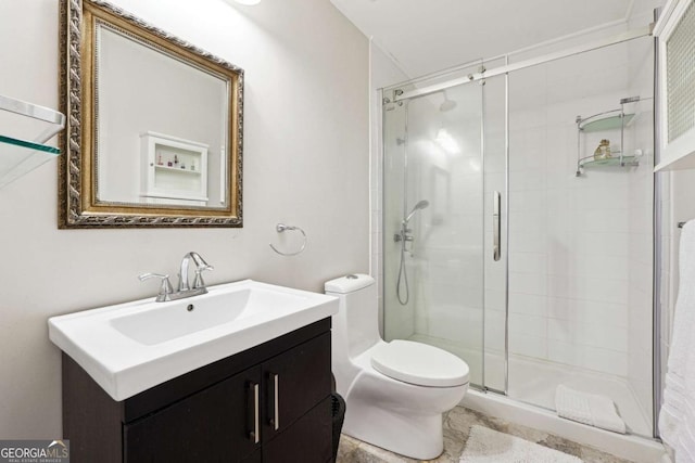 bathroom featuring toilet, a stall shower, and vanity