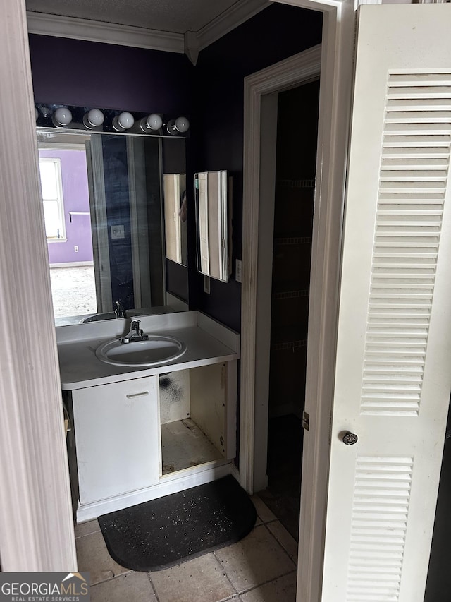 bathroom with ornamental molding and vanity
