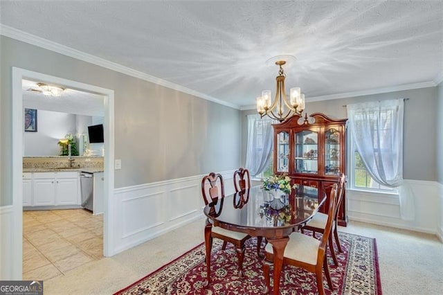 3517 Ridgemill Cir, Dacula, GA 30019 - dining space featuring a chandelier, healthy amount of natural light, light carpet, a wainscoted wall, and ornamental molding