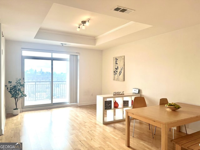 325 E Paces Ferry Rd NE Unit 1606, Atlanta, GA 30305 - dining space with crown molding, a tray ceiling, light wood-style flooring, and baseboards