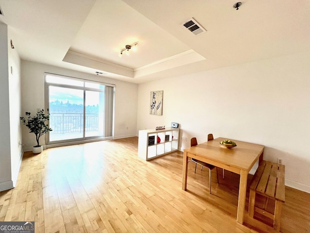 325 E Paces Ferry Rd NE Unit 1606, Atlanta, GA 30305 - dining space featuring a raised ceiling, light wood-type flooring, baseboards, and crown molding